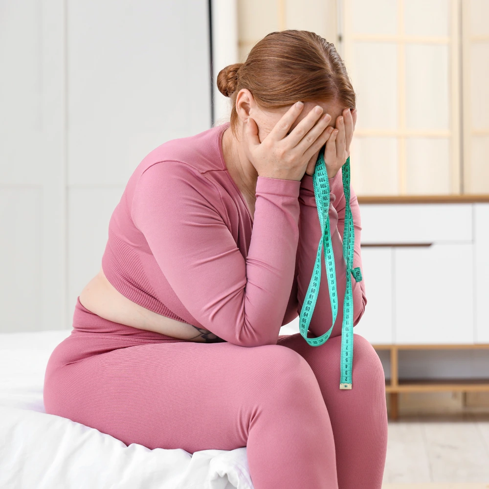 Woman frustrated by stubborn belly fat that won't move